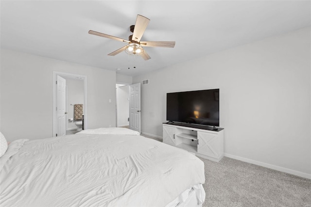 carpeted bedroom featuring visible vents, a ceiling fan, ensuite bathroom, and baseboards