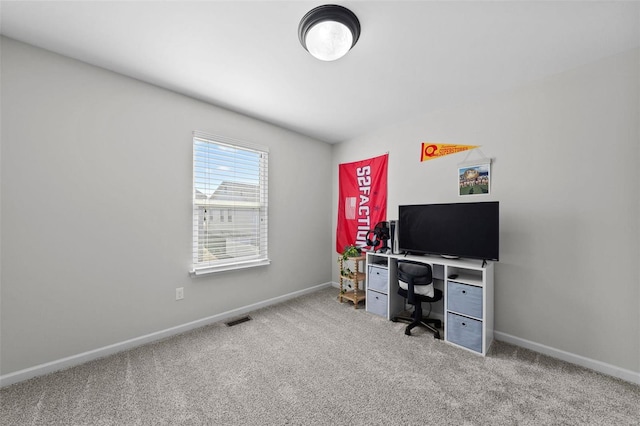 carpeted office with baseboards and visible vents