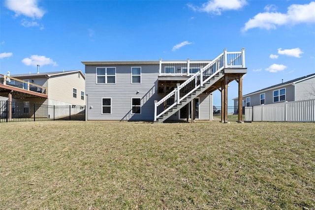 back of house featuring stairway, a deck, a yard, and a fenced backyard