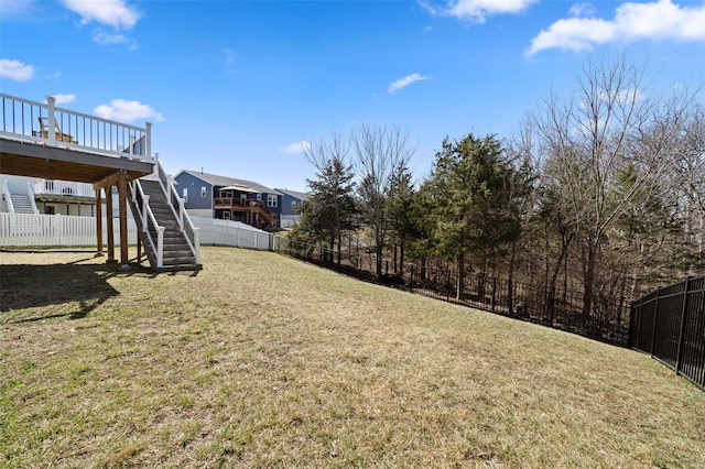 view of yard with stairway, a fenced backyard, and a deck