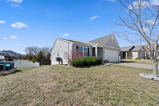 ranch-style home featuring a front yard, concrete driveway, fence, and a garage