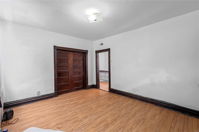 unfurnished room with baseboards, visible vents, and light wood finished floors