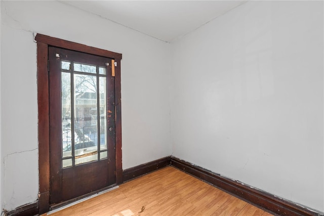 spare room with light wood-style flooring and baseboards