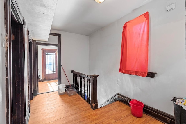 stairs featuring baseboards and wood finished floors