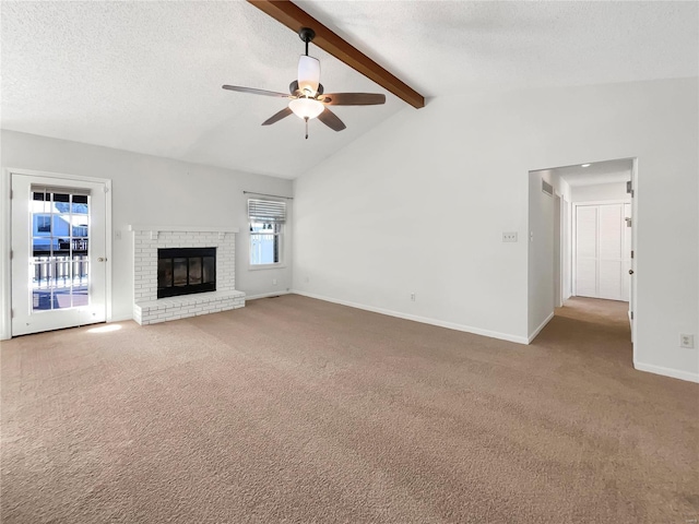 unfurnished living room featuring carpet flooring, vaulted ceiling with beams, a textured ceiling, and a fireplace