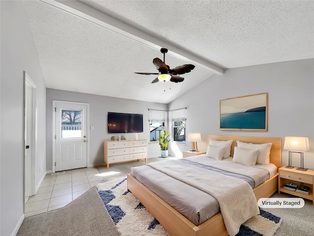 tiled bedroom featuring vaulted ceiling with beams, multiple windows, a ceiling fan, and a textured ceiling