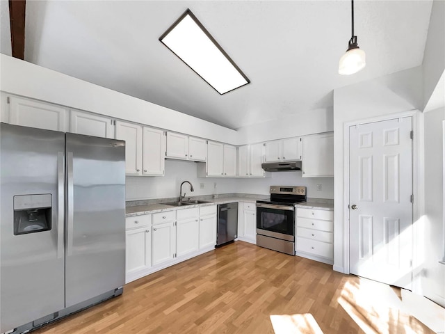 kitchen featuring under cabinet range hood, stainless steel appliances, a sink, light wood-style floors, and light countertops