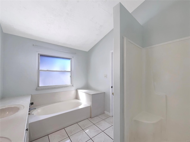 full bath with a garden tub, tile patterned flooring, walk in shower, vaulted ceiling, and vanity