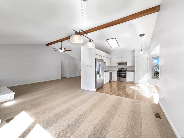 unfurnished living room featuring beam ceiling, visible vents, light wood-style flooring, a ceiling fan, and baseboards