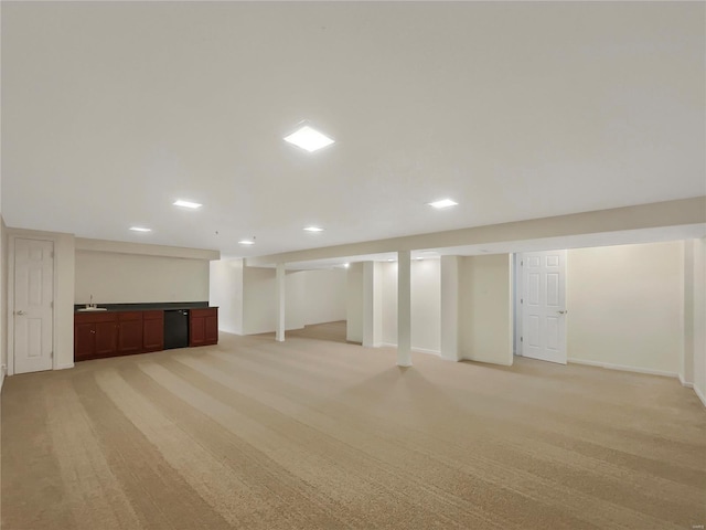 finished basement with baseboards and light colored carpet