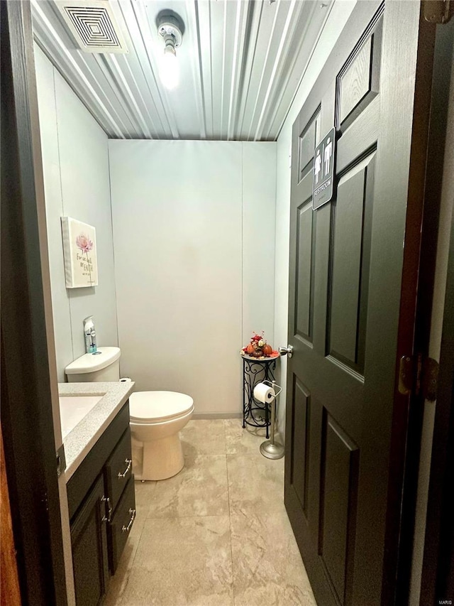 bathroom with visible vents, toilet, and vanity