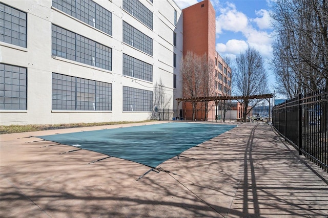 view of swimming pool with fence