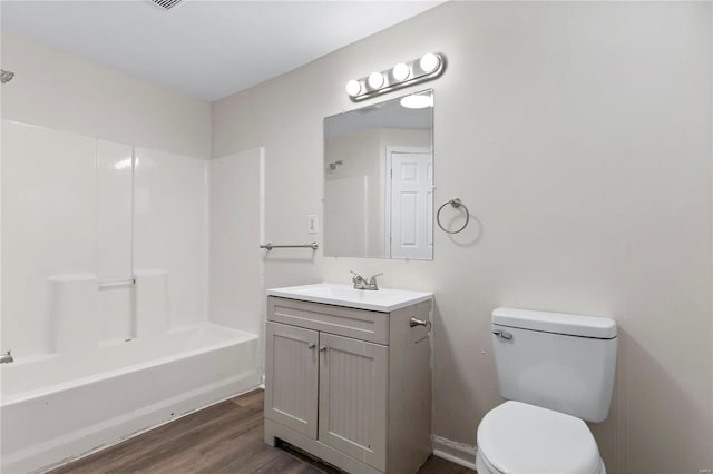 full bathroom featuring shower / bathing tub combination, vanity, toilet, and wood finished floors