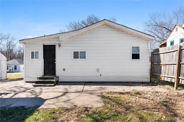 back of house with entry steps, a patio, and fence