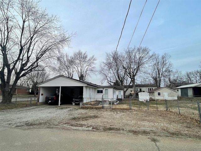 view of front of house featuring a chimney, a fenced front yard, gravel driveway, and a gate