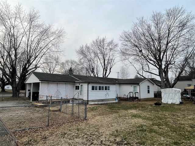 rear view of property with entry steps, a lawn, a chimney, and fence