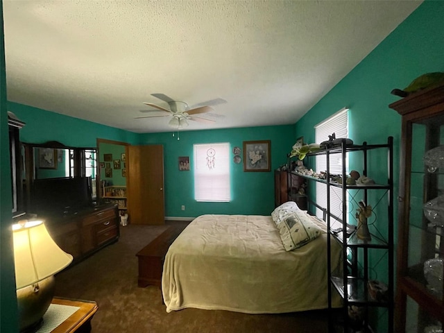 carpeted bedroom featuring a ceiling fan and a textured ceiling