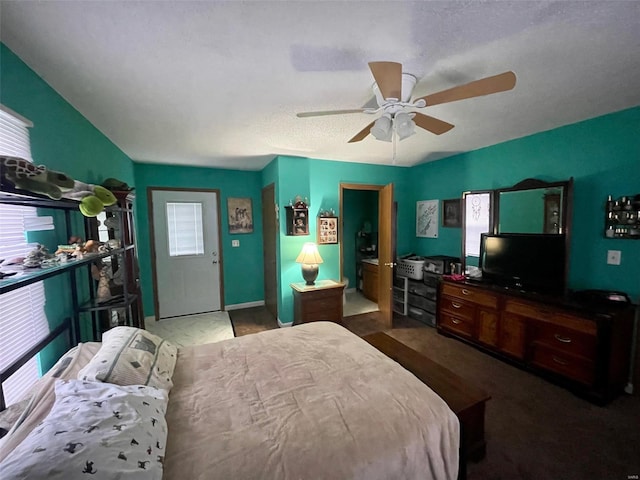 bedroom featuring ceiling fan, multiple windows, and baseboards