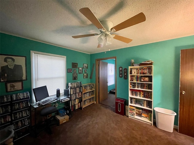 carpeted home office with a ceiling fan, ornamental molding, and a textured ceiling