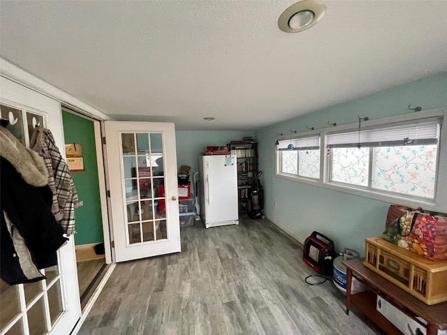 misc room featuring a textured ceiling and wood finished floors