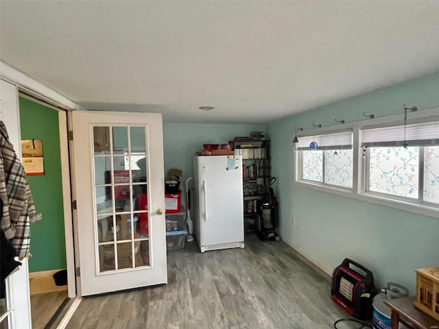 interior space with baseboards and wood finished floors