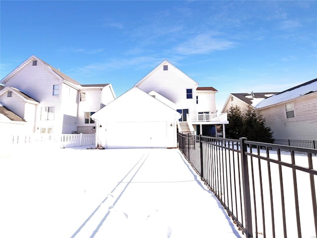 exterior space featuring an attached garage, fence, and a balcony