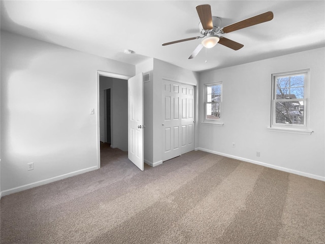 unfurnished bedroom featuring a ceiling fan, carpet, baseboards, and a closet