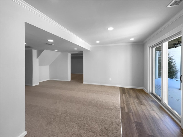 basement with visible vents, baseboards, and crown molding