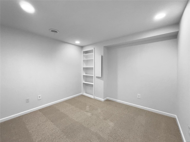 carpeted spare room with baseboards, visible vents, and recessed lighting