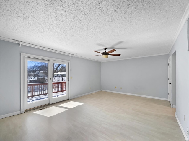 unfurnished room featuring a textured ceiling, visible vents, baseboards, light wood-style floors, and crown molding