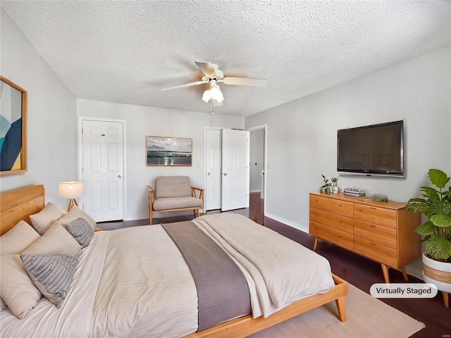 bedroom with a textured ceiling, wood finished floors, a ceiling fan, and baseboards