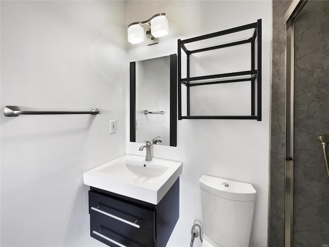 bathroom with toilet and vanity