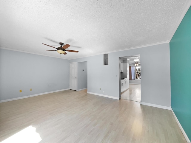 unfurnished room with ceiling fan, a textured ceiling, light wood-style flooring, visible vents, and ornamental molding