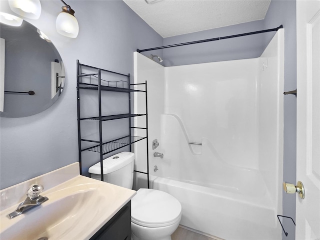 bathroom with vanity, a textured ceiling, toilet, and shower / bathtub combination