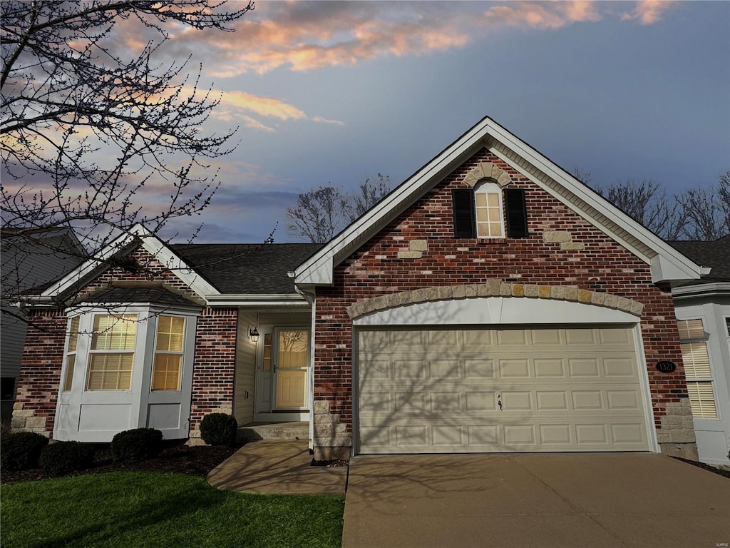 view of front facade with a garage, concrete driveway, and brick siding