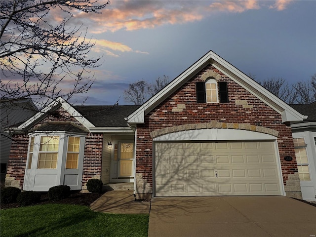 view of front facade with a garage, concrete driveway, and brick siding