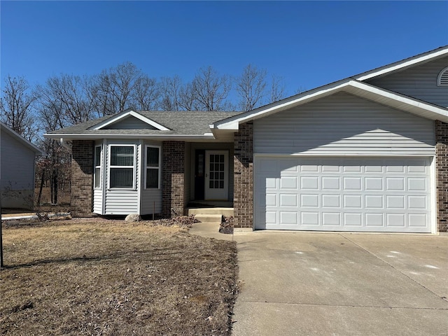 ranch-style home featuring a garage, driveway, brick siding, and roof with shingles