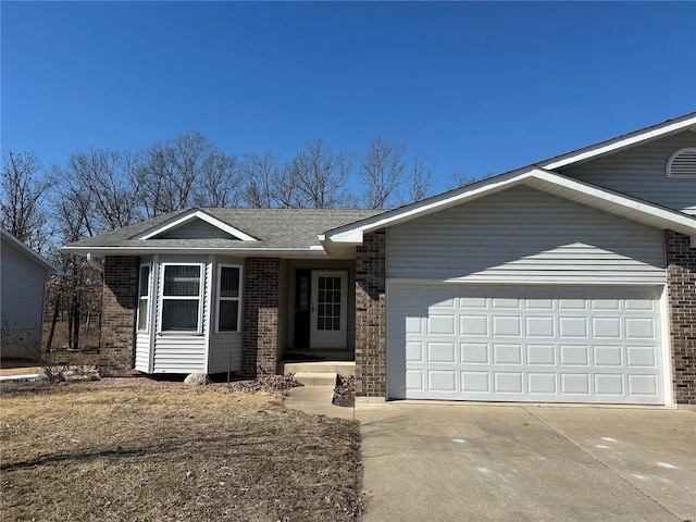 ranch-style home with a garage, concrete driveway, brick siding, and roof with shingles