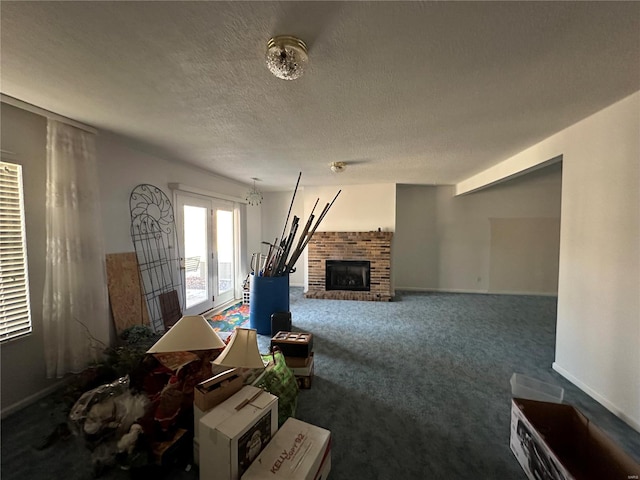 carpeted living area featuring a textured ceiling and a fireplace