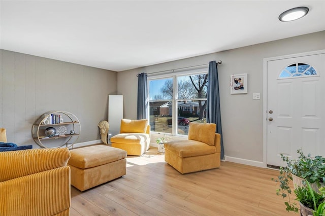 living room with light wood-style flooring and baseboards