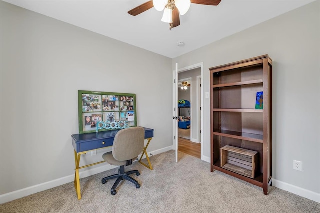 office area featuring baseboards, carpet floors, and a ceiling fan