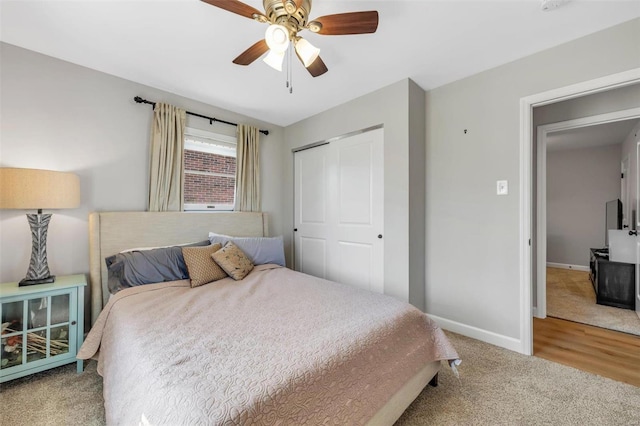 bedroom featuring a closet, baseboards, carpet, and ceiling fan