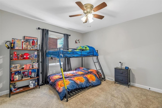 carpeted bedroom featuring visible vents, baseboards, and ceiling fan