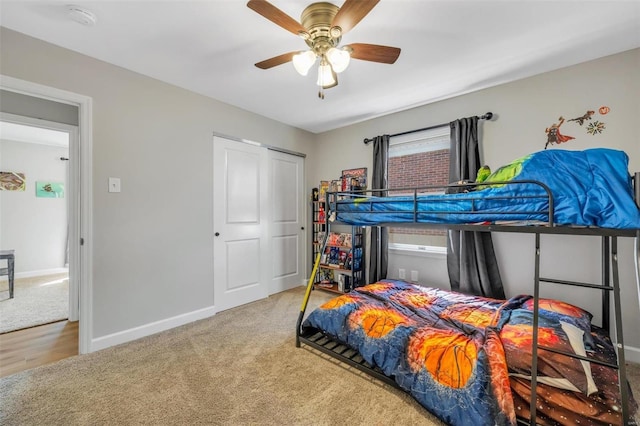 carpeted bedroom with baseboards and ceiling fan