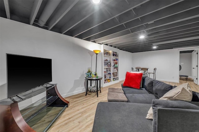 living area with baseboards and wood finished floors