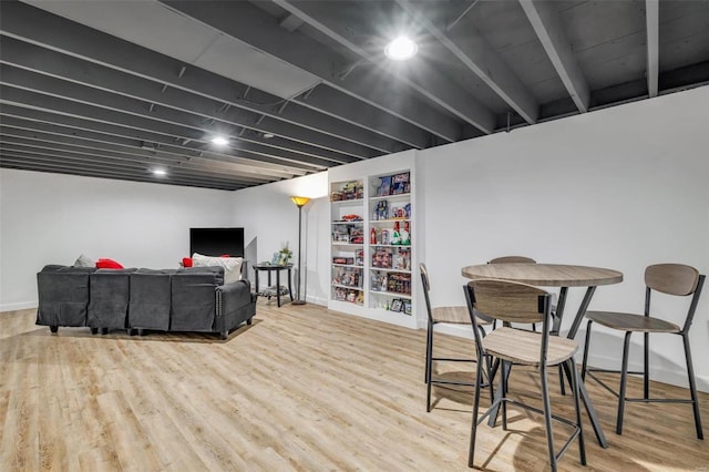 living area with wood finished floors and baseboards