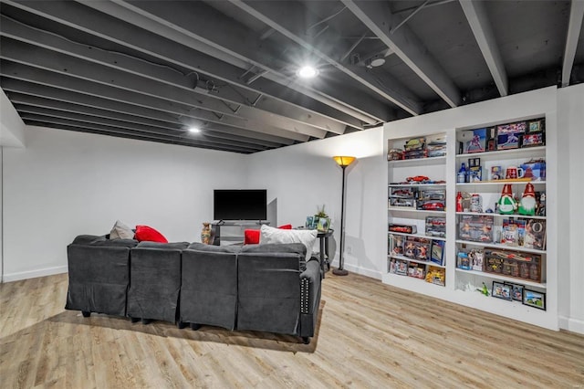 living area with baseboards and wood finished floors