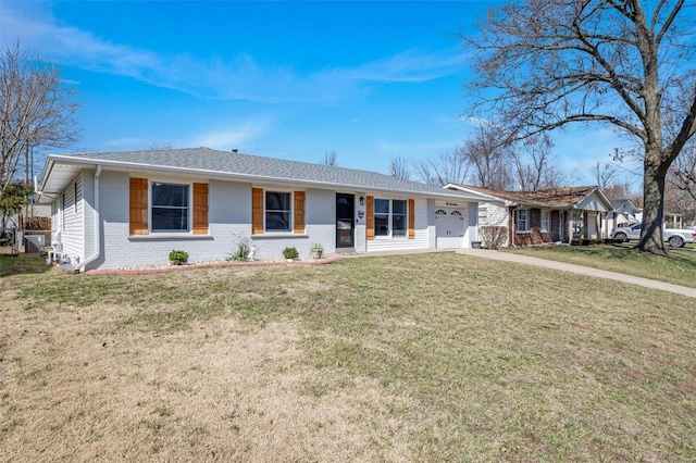 ranch-style house with a front lawn, brick siding, and a garage