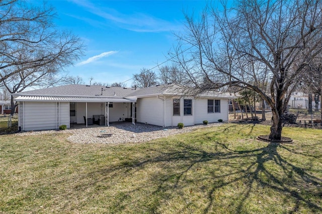 rear view of house featuring a lawn, a shingled roof, a patio, and fence