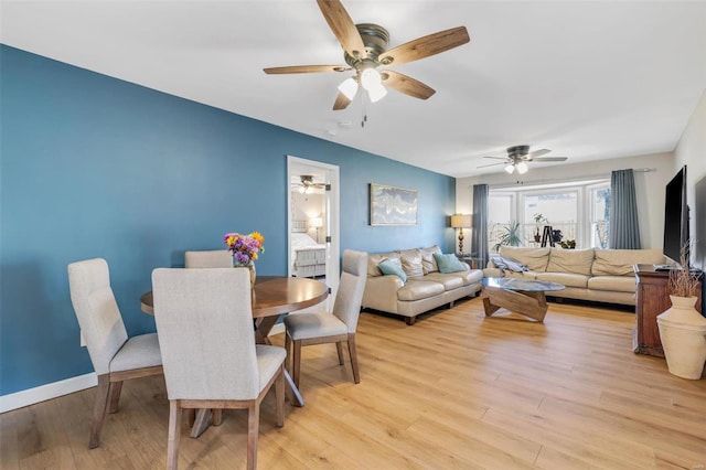 dining area featuring ceiling fan, baseboards, and light wood-style floors